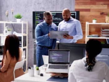 African Business Team Working On Computer. Software App Development